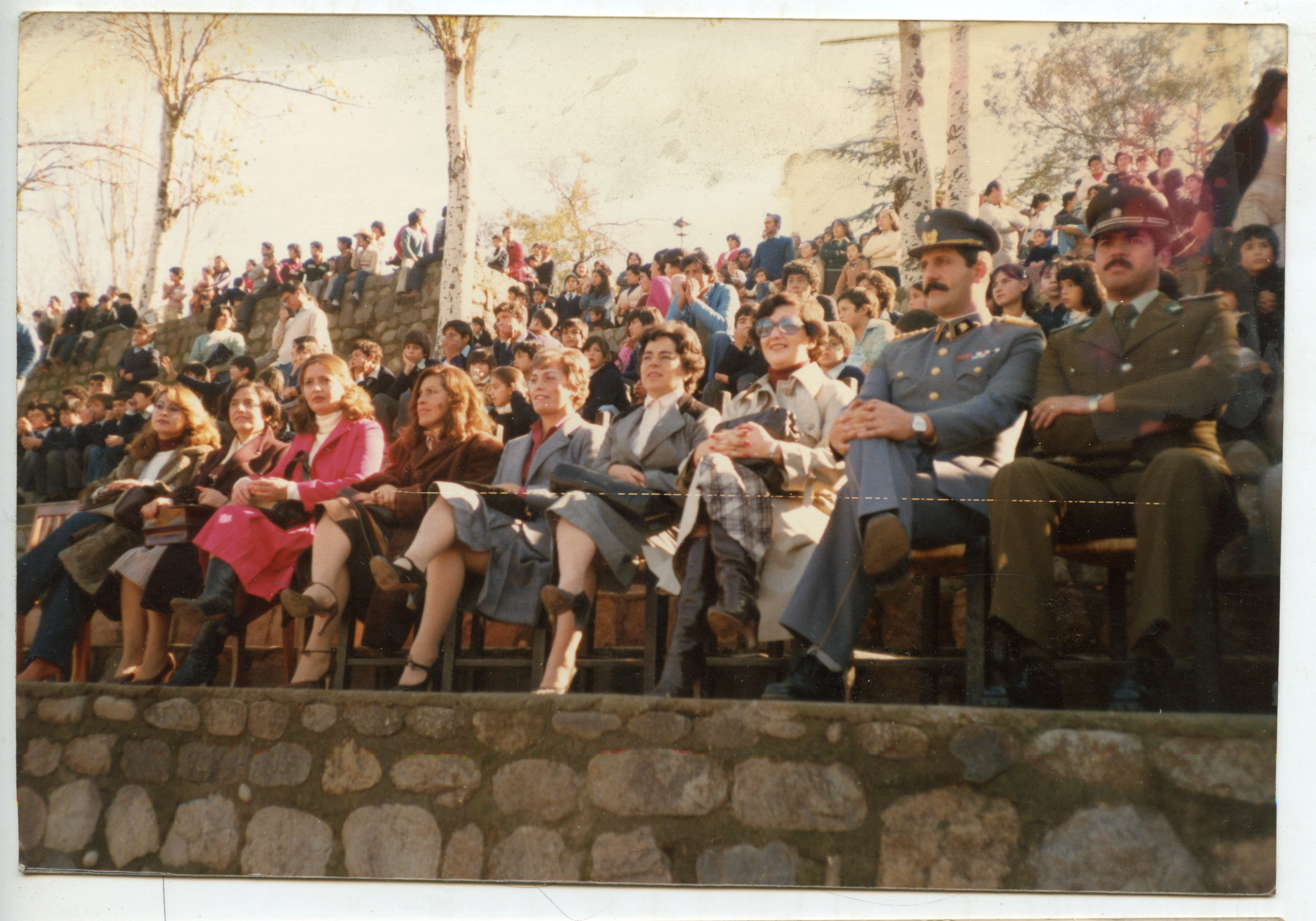 Autoridades sentadas durante desfile, Circa 1980. Calle Barnechea